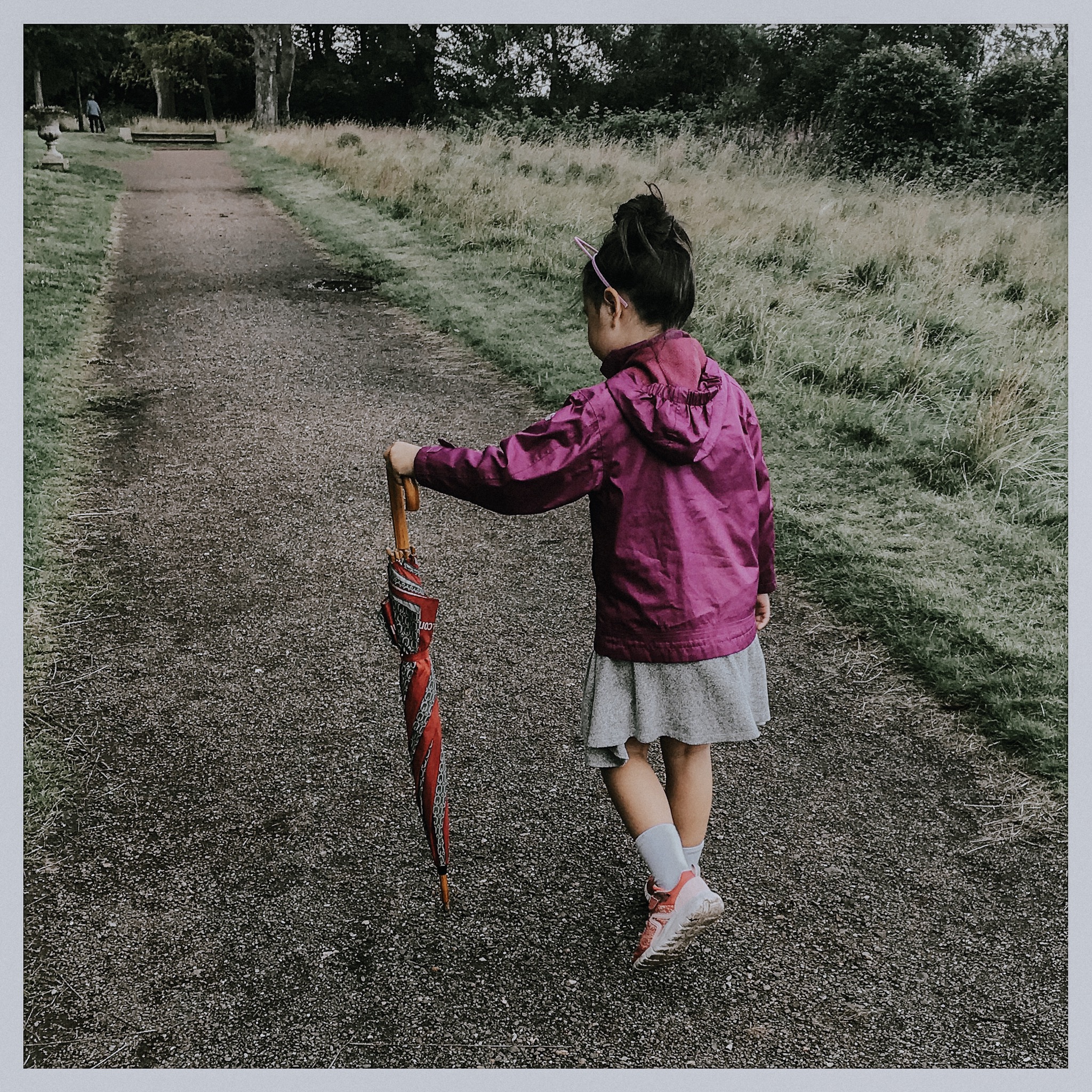 girl walking with umbrella