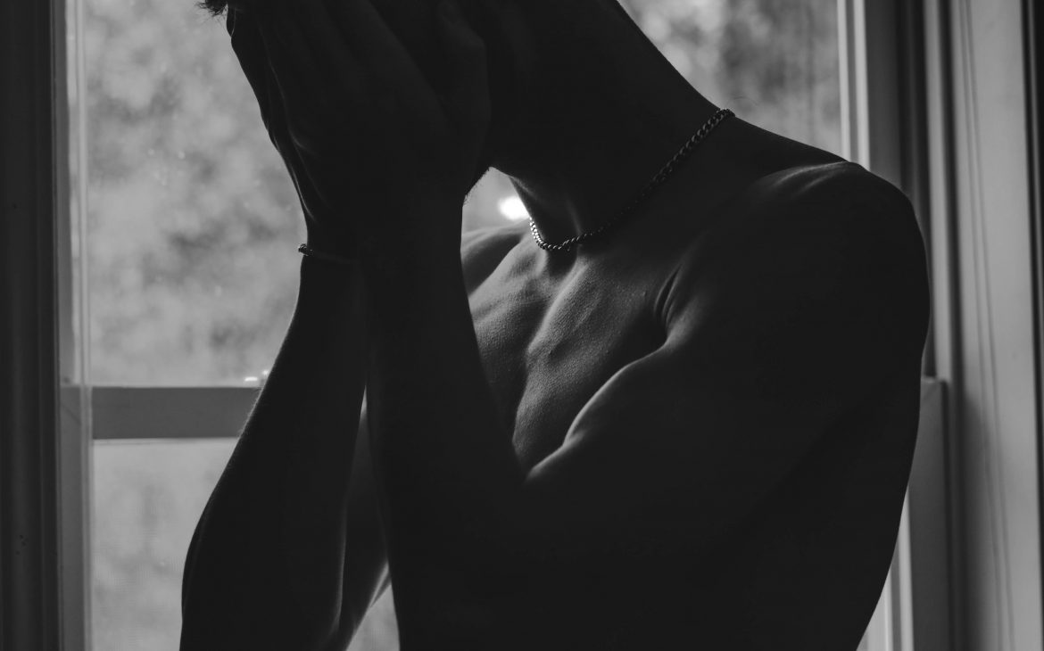 monochrome photo of man showing sadness