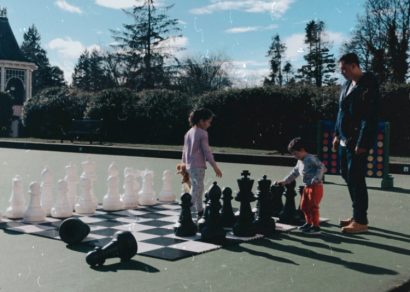 family playing outdoor chess