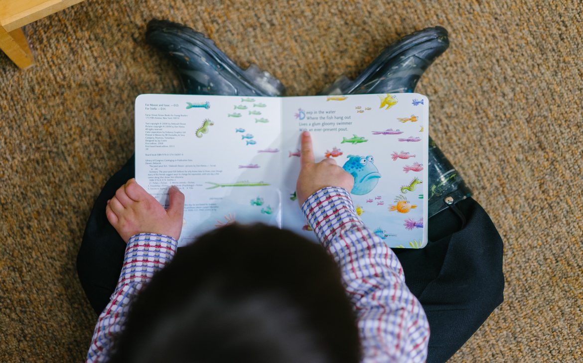 photo of boy reading a book