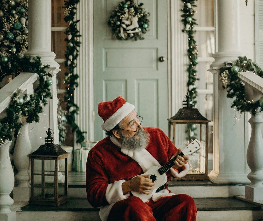 man in santa claus costume sitting on the door way