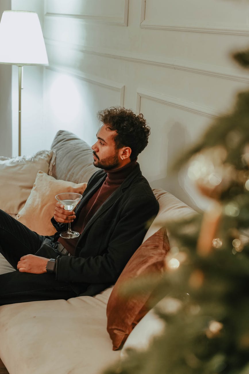 man in black jacket sitting on a couch
