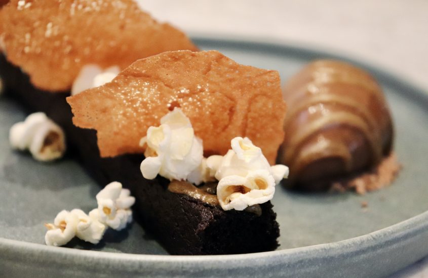 Chocolate sponge with salted caramel sauce and popcorn 